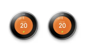 two nest learning thermostat displaying 20 with an orange screen